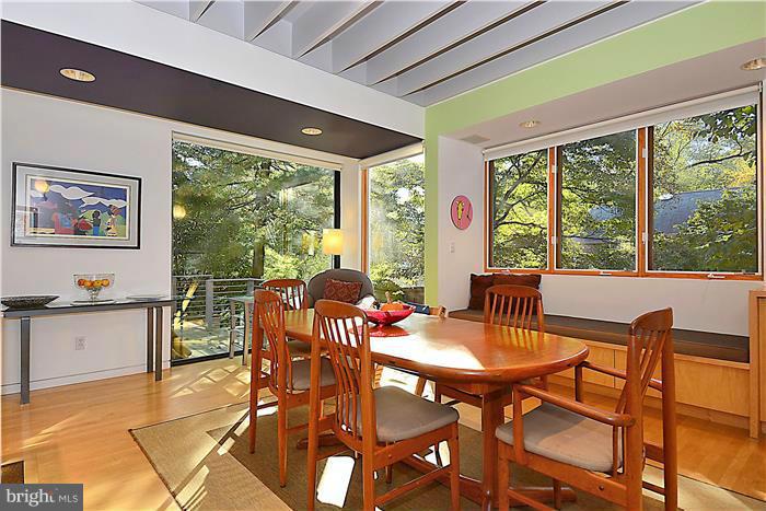 9206 Saybrook Avenue Silver Spring, MD 20901 - Photo 5 of 30 a view of a dining room with furniture large windows and wooden floor