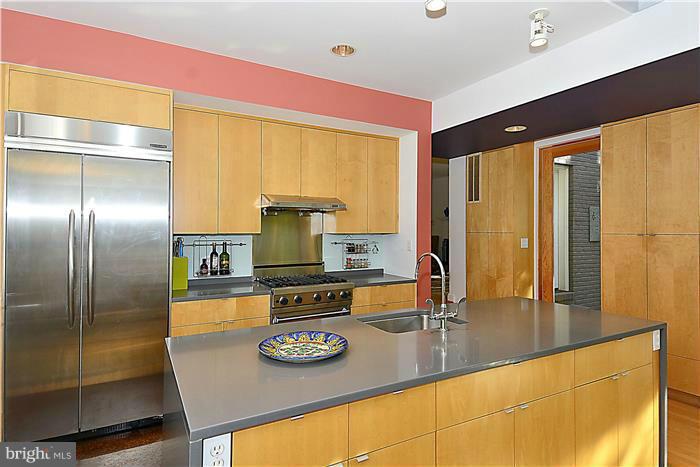 9206 Saybrook Avenue Silver Spring, MD 20901 - Photo 10 of 30 a kitchen with a table chairs and refrigerator