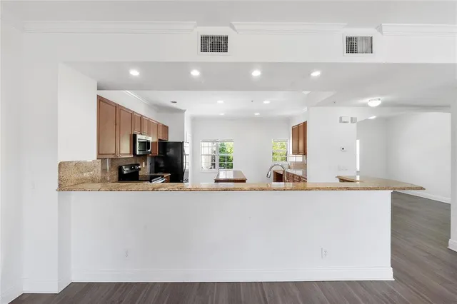 a large room with kitchen island a sink a counter top space and a center island