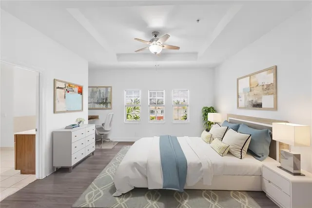 a bedroom with a bed and ceiling fan