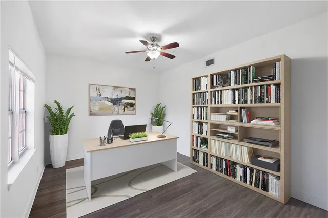 a living room with furniture and a book shelf