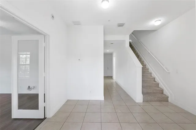 a view of hallway with stairs and a bathroom