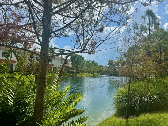 a view of a patio with a dining table and chairs with wooden floor and fence