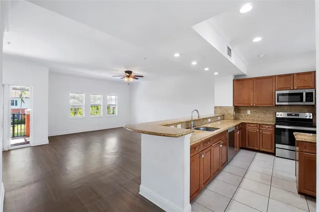 a kitchen with stainless steel appliances granite countertop a stove and a sink
