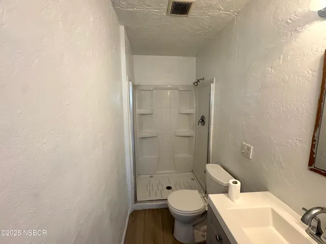 a bathroom with a granite countertop toilet a sink and a bathtub