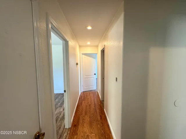 a view of a bathroom from a hallway