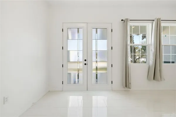 an empty room with windows and bathroom
