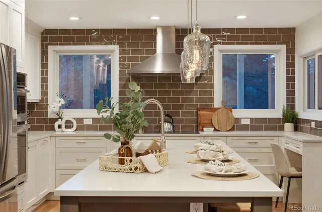 a kitchen with a sink stove and kitchen island