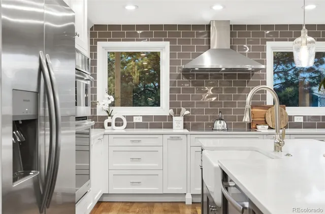 a kitchen with stainless steel appliances a sink stove and cabinets