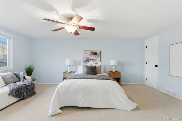 a bedroom with a bed and ceiling fan