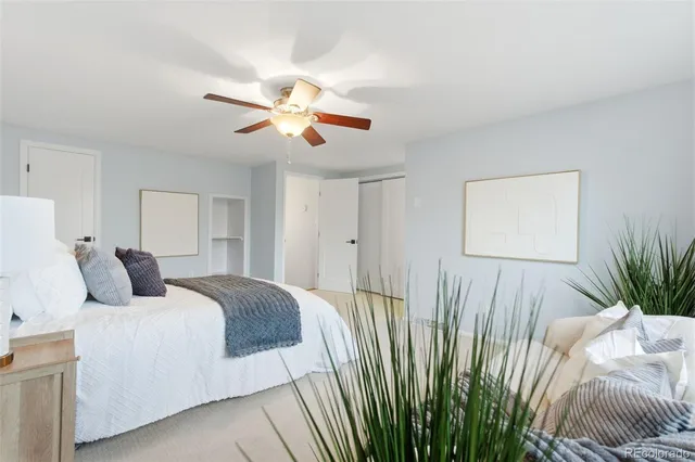 a bedroom with a large bed and a chandelier