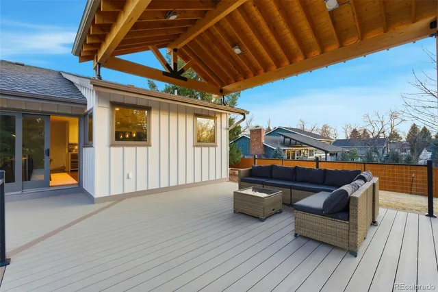 a view of a roof deck with couches and sky view