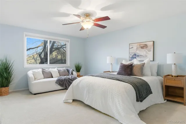 a spacious bedroom with a bed and a couch