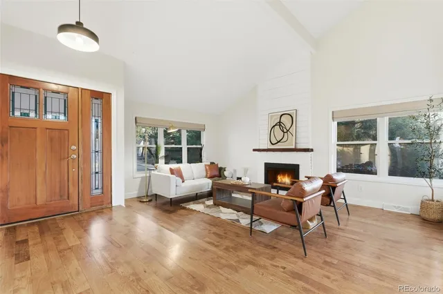 a living room with furniture and a fireplace