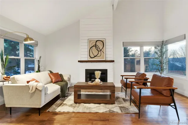 a living room with furniture and a fireplace