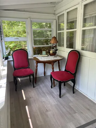 a living room with furniture a ceiling fan and a window
