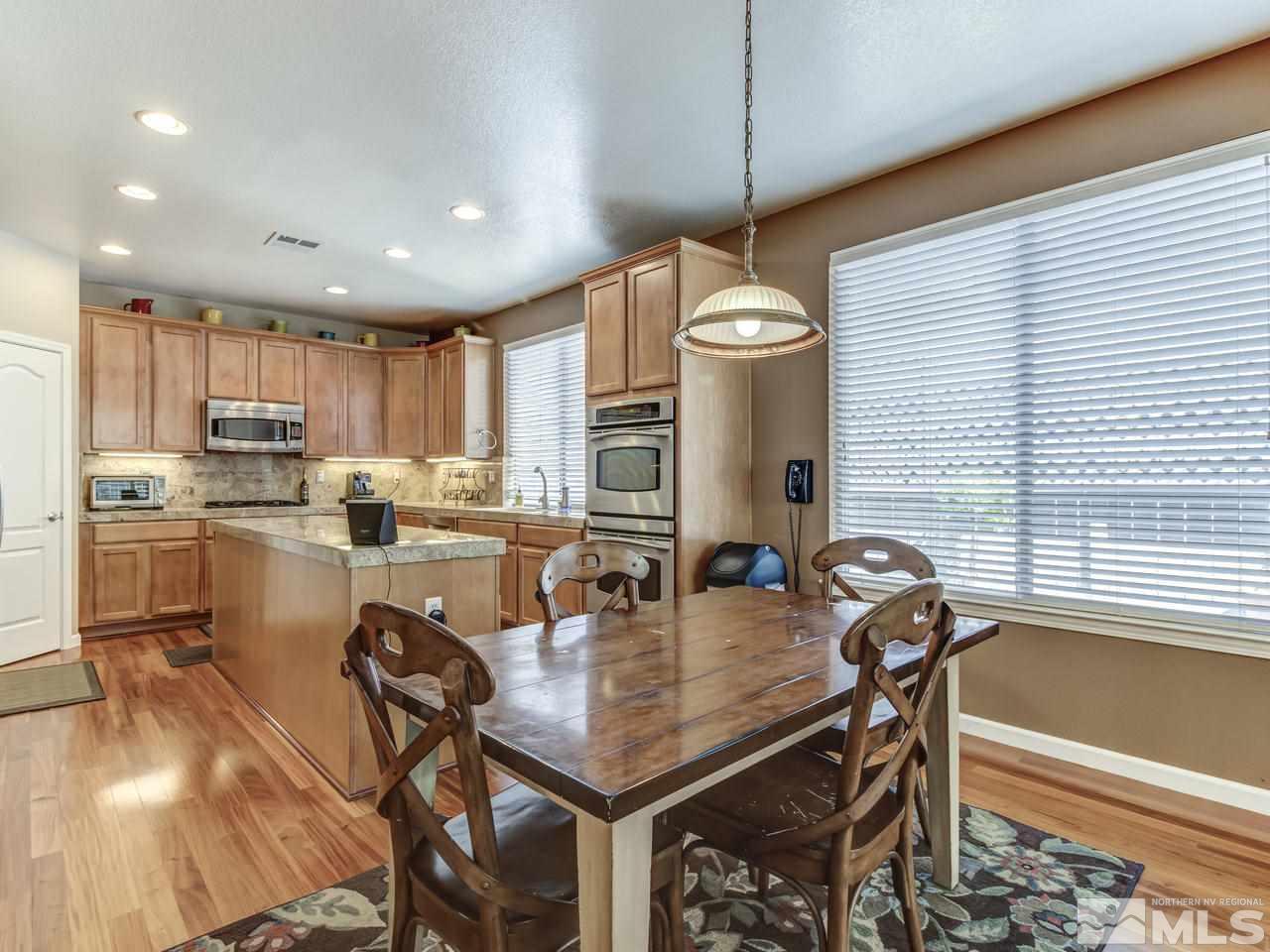 560 Secretariat Court Reno, NV 89521 - Photo 11 of 25 a kitchen with a table chairs microwave and cabinets