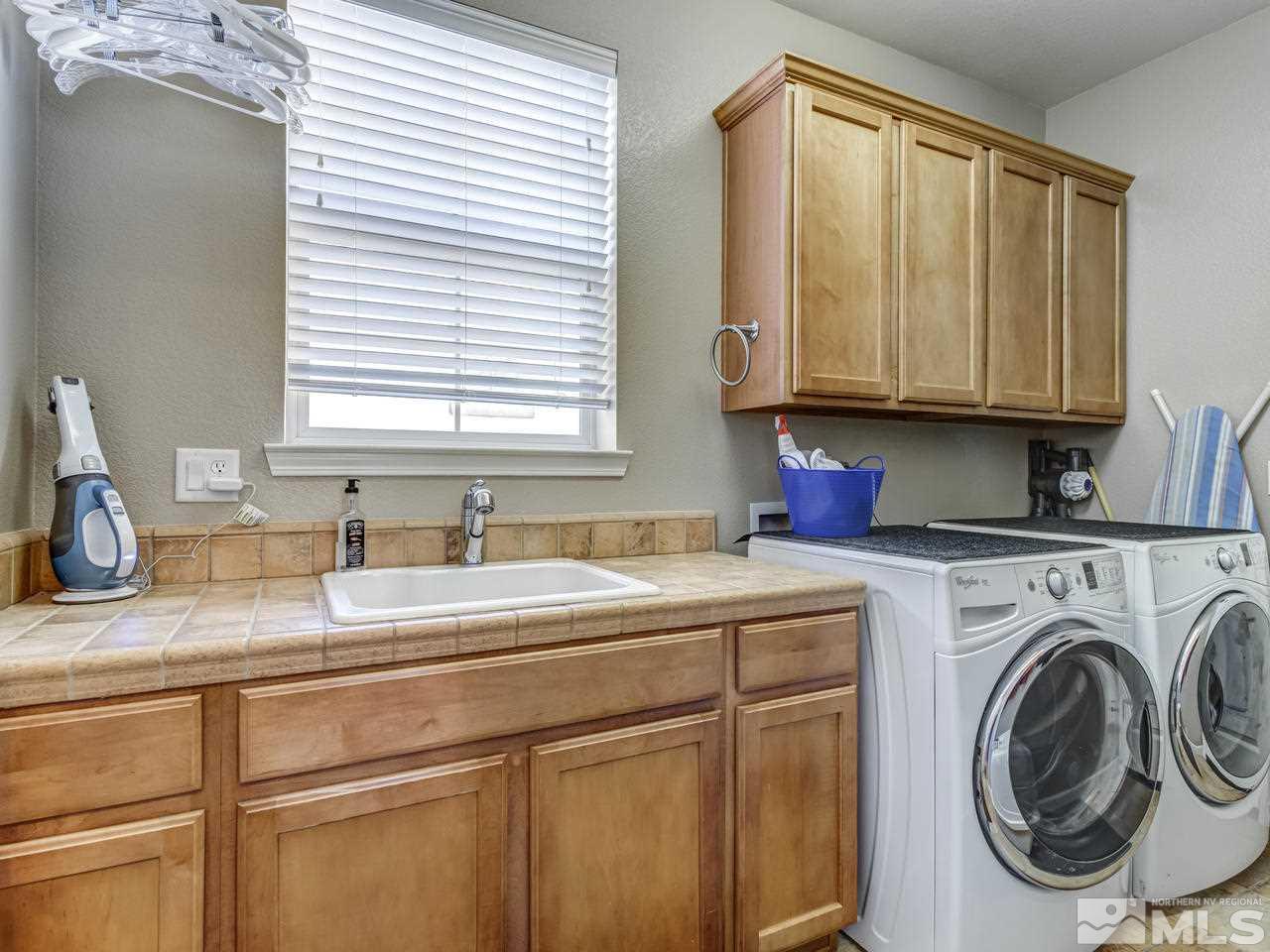 560 Secretariat Court Reno, NV 89521 - Photo 14 of 25 a kitchen with stainless steel appliances granite countertop a sink and a window