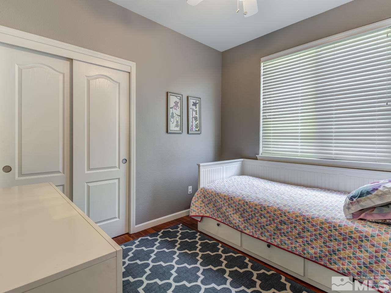 560 Secretariat Court Reno, NV 89521 - Photo 20 of 25 a bedroom with a bed and a window