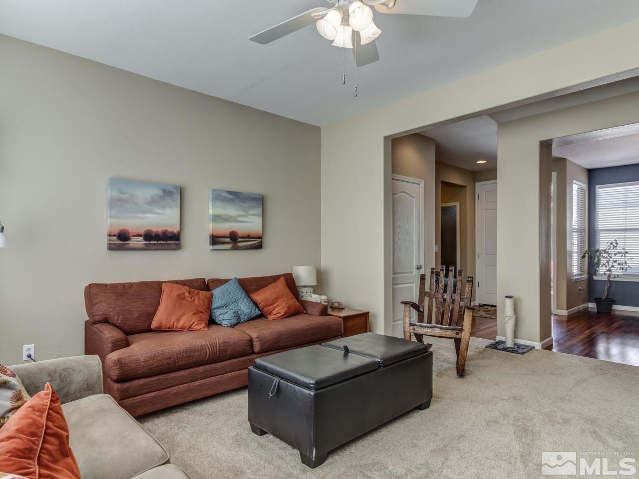 560 Secretariat Court Reno, NV 89521 - Photo 7 of 25 a living room with furniture and a chandelier