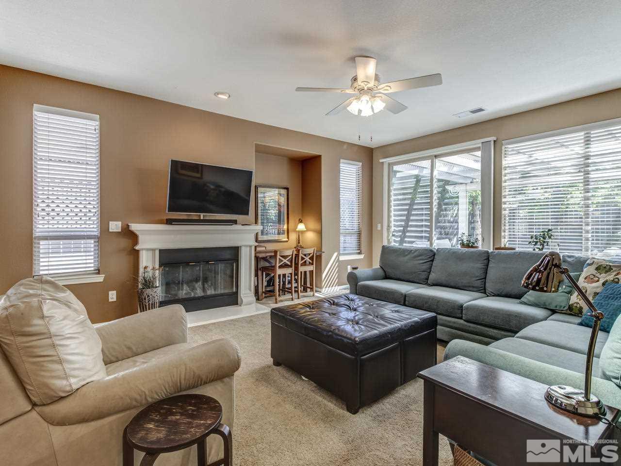 560 Secretariat Court Reno, NV 89521 - Photo 8 of 25 a living room with furniture a fireplace and a flat screen tv