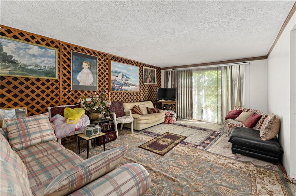 216 Catalpa Place Pittsburgh, PA 15228 - Photo 12 of 43 a living room with furniture wooden floor and a large window