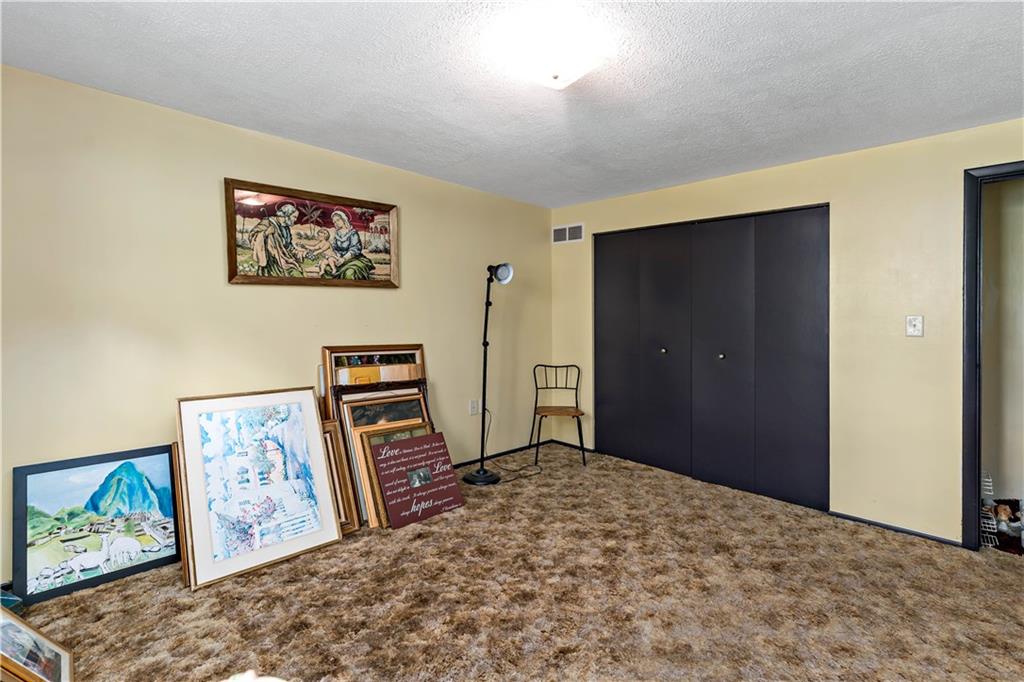 216 Catalpa Place Pittsburgh, PA 15228 - Photo 19 of 43 a bedroom with a bed and a painting on the wall