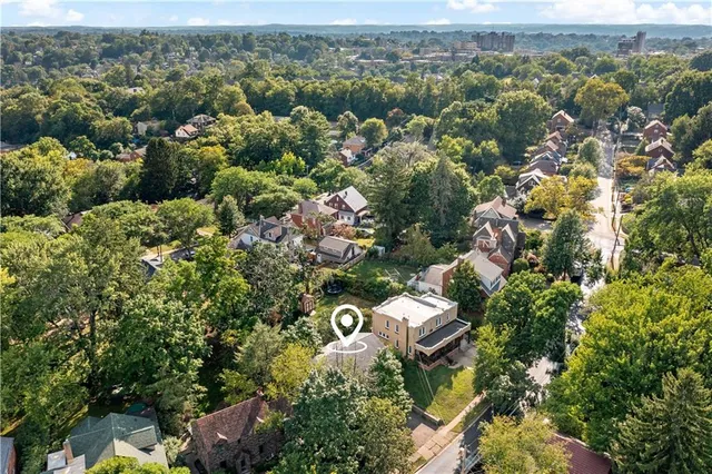 an aerial view of a house with a yard and outdoor seating
