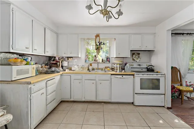 a kitchen with a white cabinets and white appliances