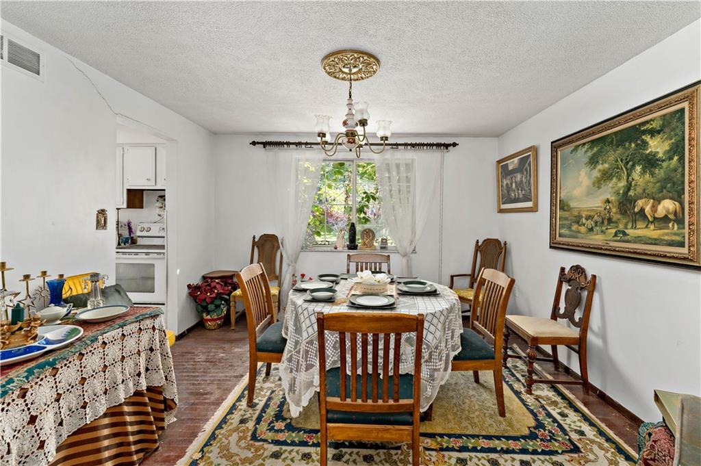 216 Catalpa Place Pittsburgh, PA 15228 - Photo 5 of 43 a dining room with furniture a rug and a chandelier