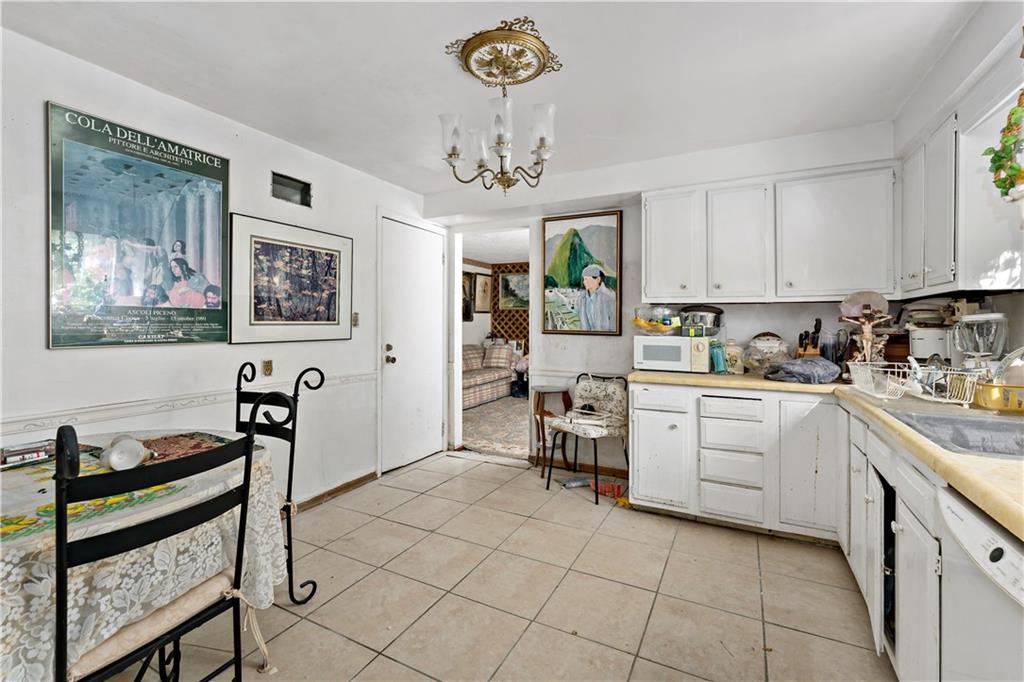 216 Catalpa Place Pittsburgh, PA 15228 - Photo 9 of 43 a kitchen with stainless steel appliances granite countertop a stove top oven a sink a counter space and cabinets