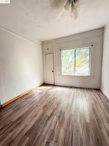 a view of kitchen with kitchen island microwave and wooden floor