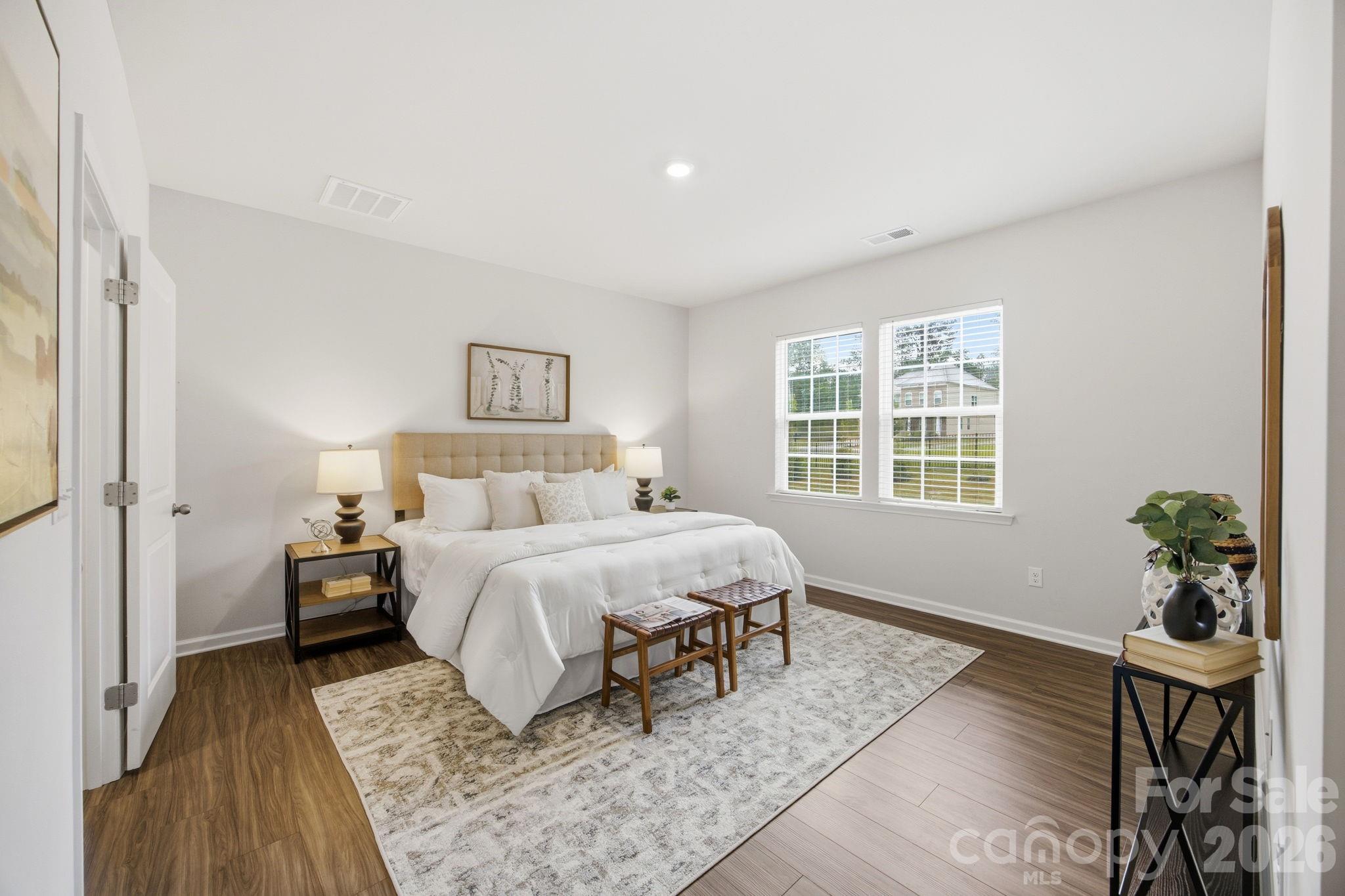 234 Hamptons Cove Road Troutman, NC 28166 - Photo 14 of 32 a bed room with a bed and a table
