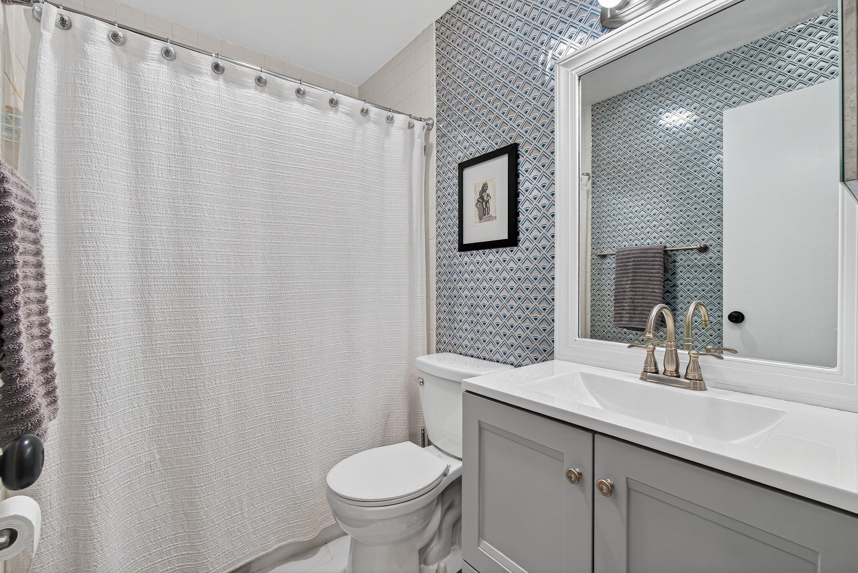 13465 Fishtail Palm Court, Unit D Delray Beach, FL 33484 - Photo 20 of 29 a bathroom with a sink toilet and shower