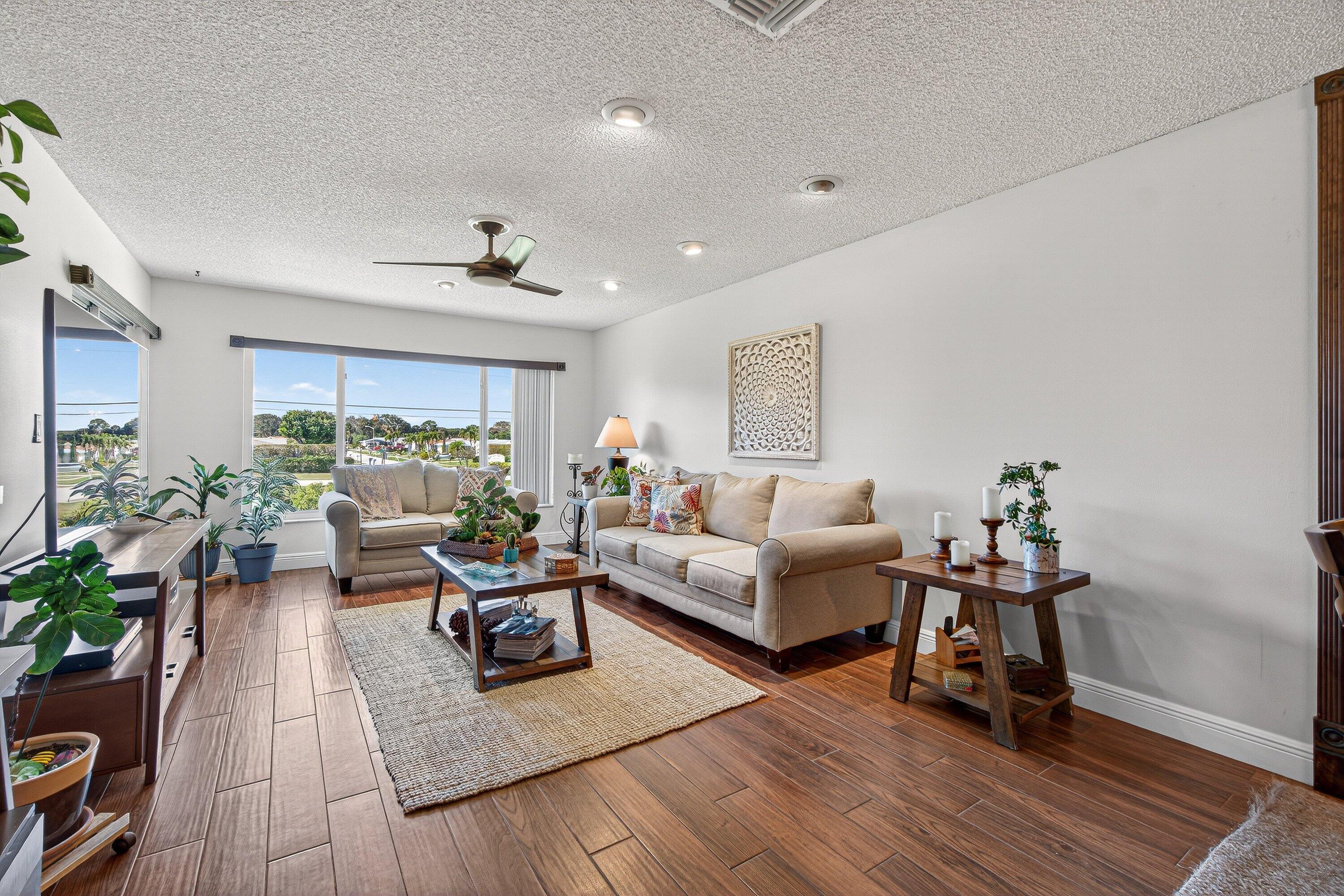13465 Fishtail Palm Court, Unit D Delray Beach, FL 33484 - Photo 10 of 29 a living room with furniture and wooden floor