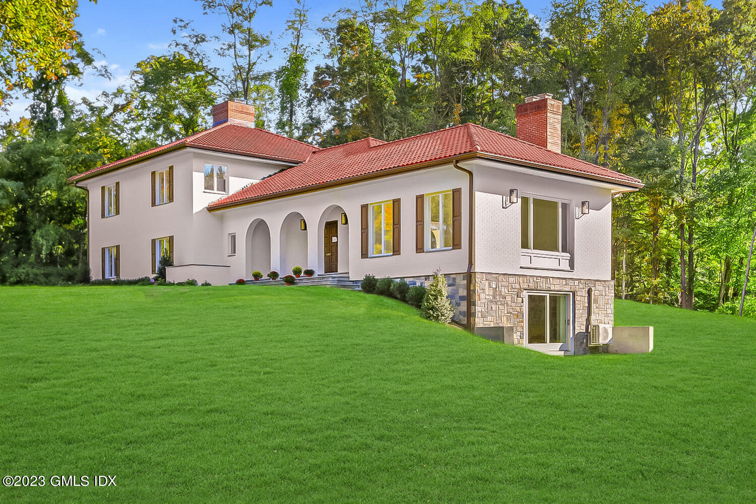 10 Harkim Road Greenwich, CT 06831 - Photo 30 of 39 a front view of a house with a garden