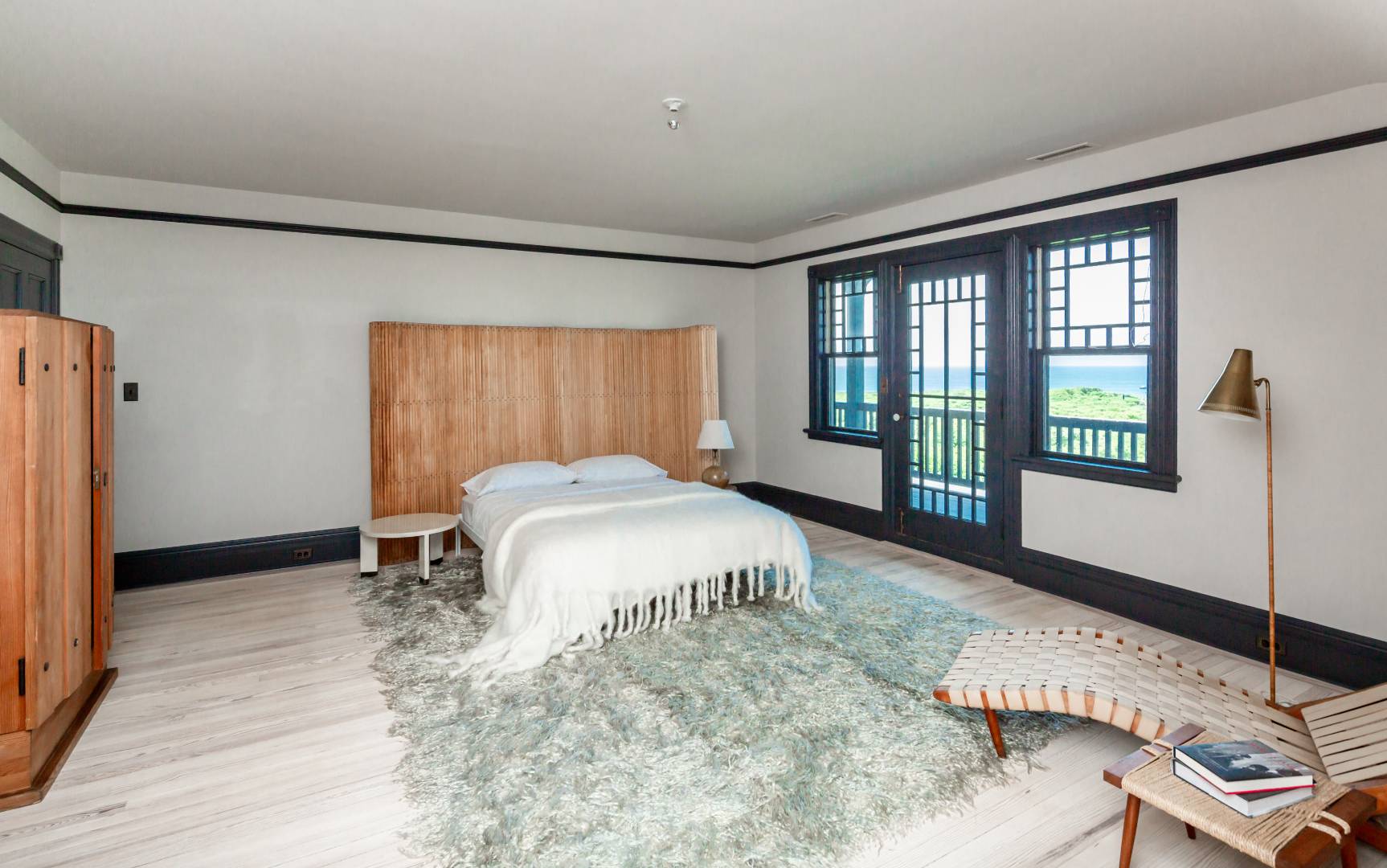 153 Deforest Road Montauk, NY 11954 - Photo 13 of 23 a spacious bedroom with a large bed and a window