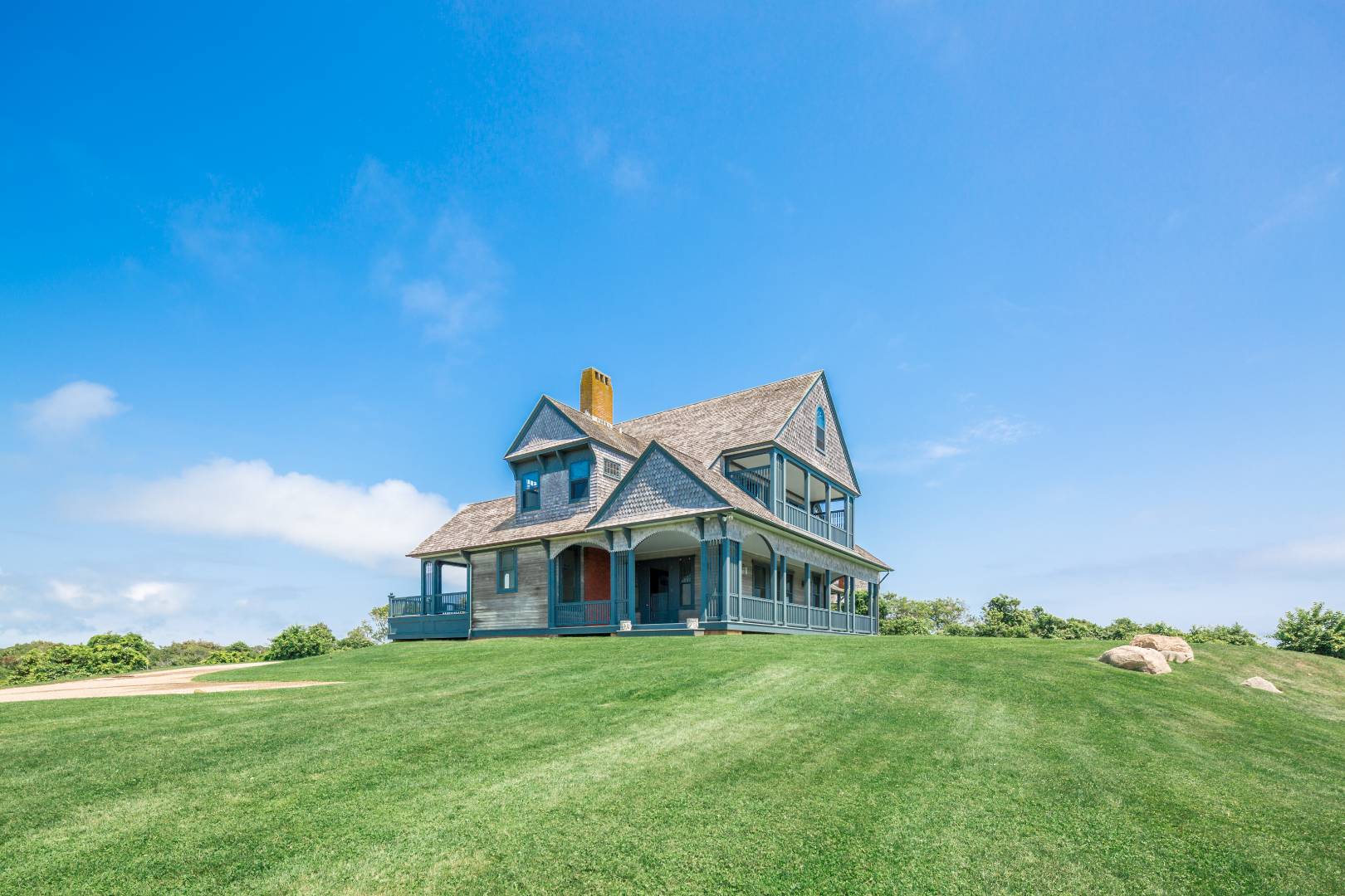 153 Deforest Road Montauk, NY 11954 - Photo 3 of 23 a front view of a house with a garden