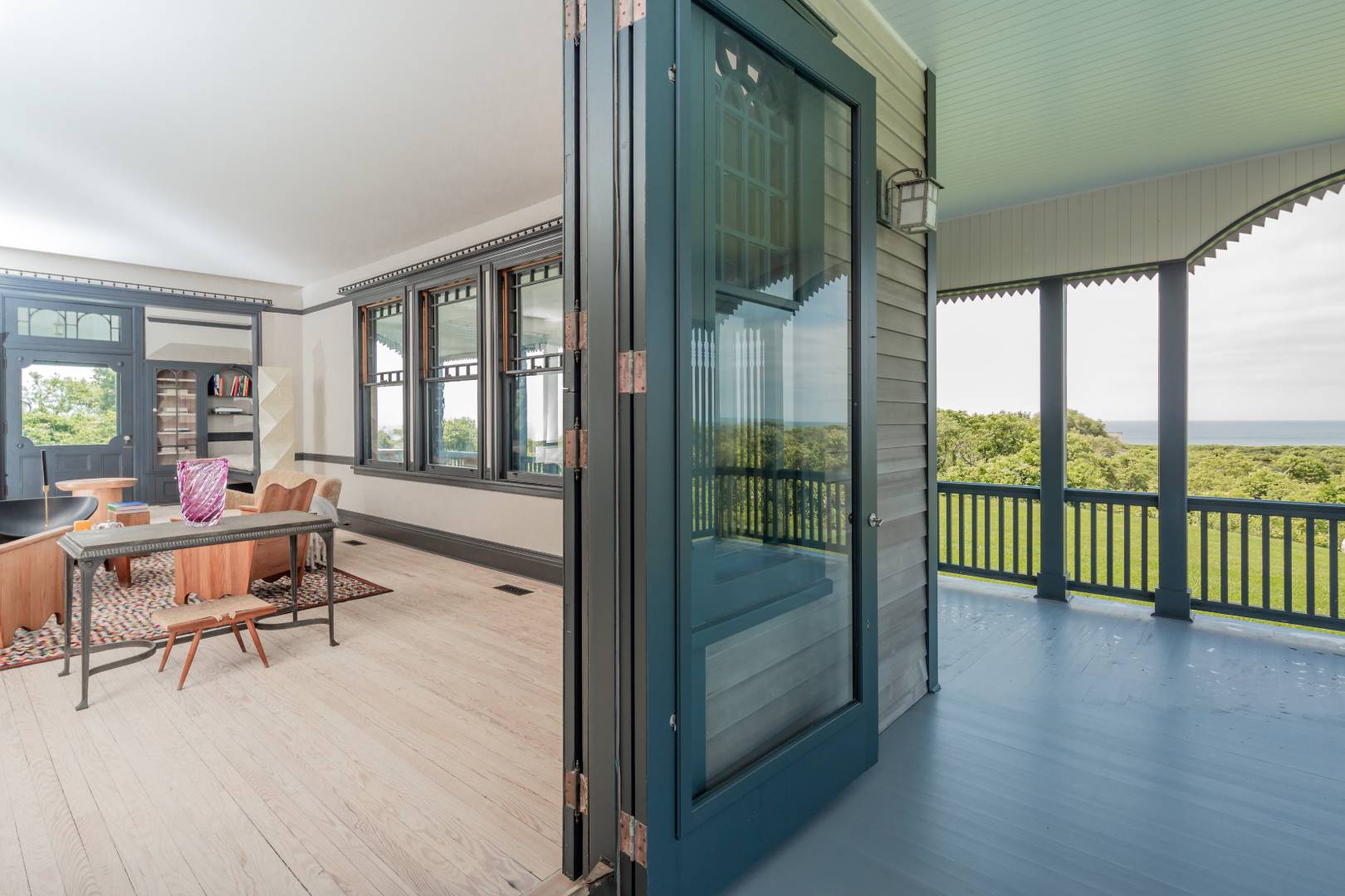 153 Deforest Road Montauk, NY 11954 - Photo 9 of 23 a living room with furniture and a floor to ceiling window