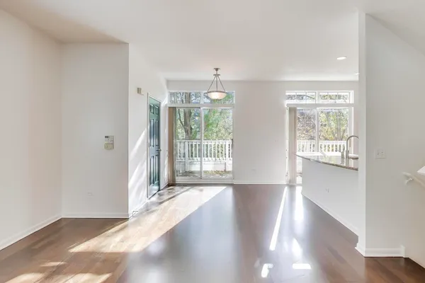 a view of entryway with wooden floor and windows