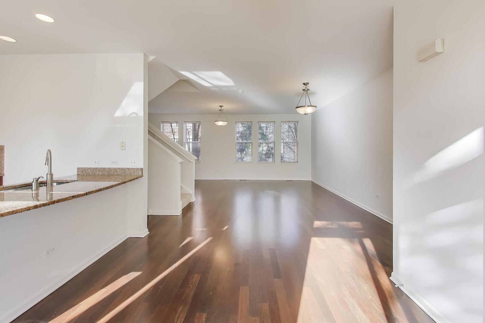 513 Grove Lane Forest Park, IL 60130 - Photo 13 of 34 a hallway with wooden floor table and chairs