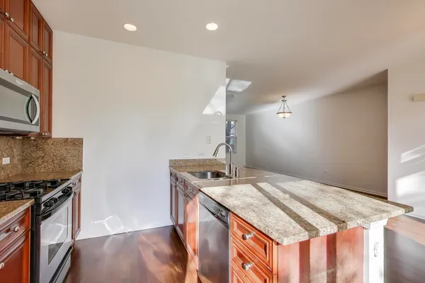a kitchen with a sink a stove and a refrigerator