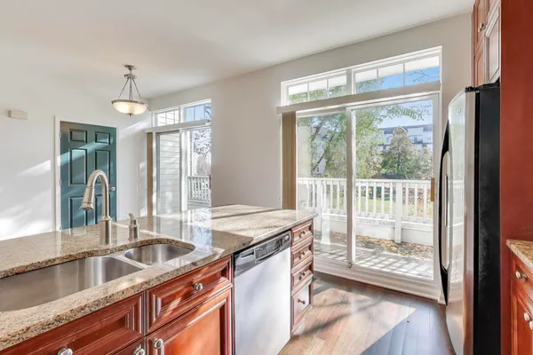 a kitchen with granite countertop a sink and a large window