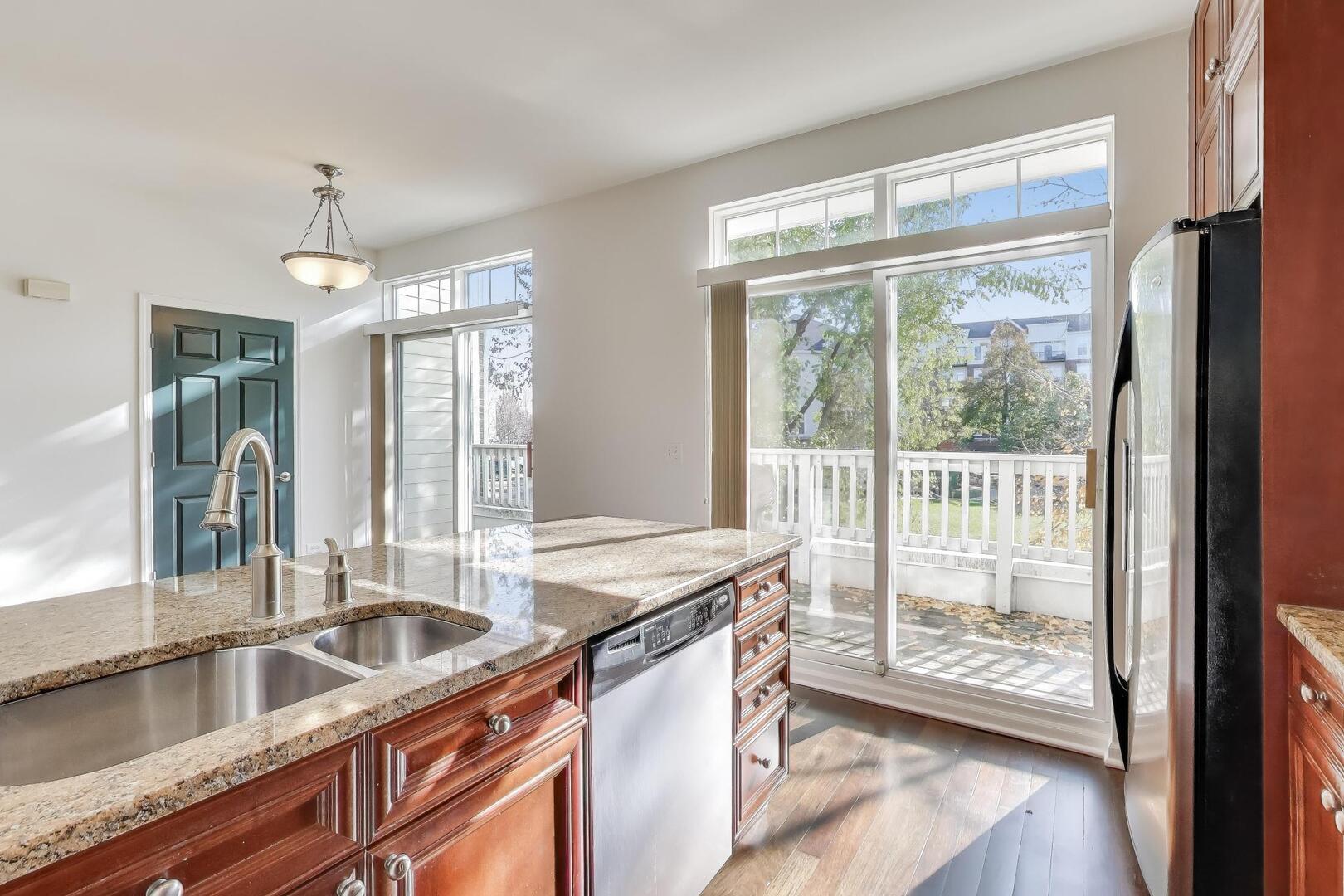 513 Grove Lane Forest Park, IL 60130 - Photo 16 of 34 a kitchen with granite countertop a sink and a large window