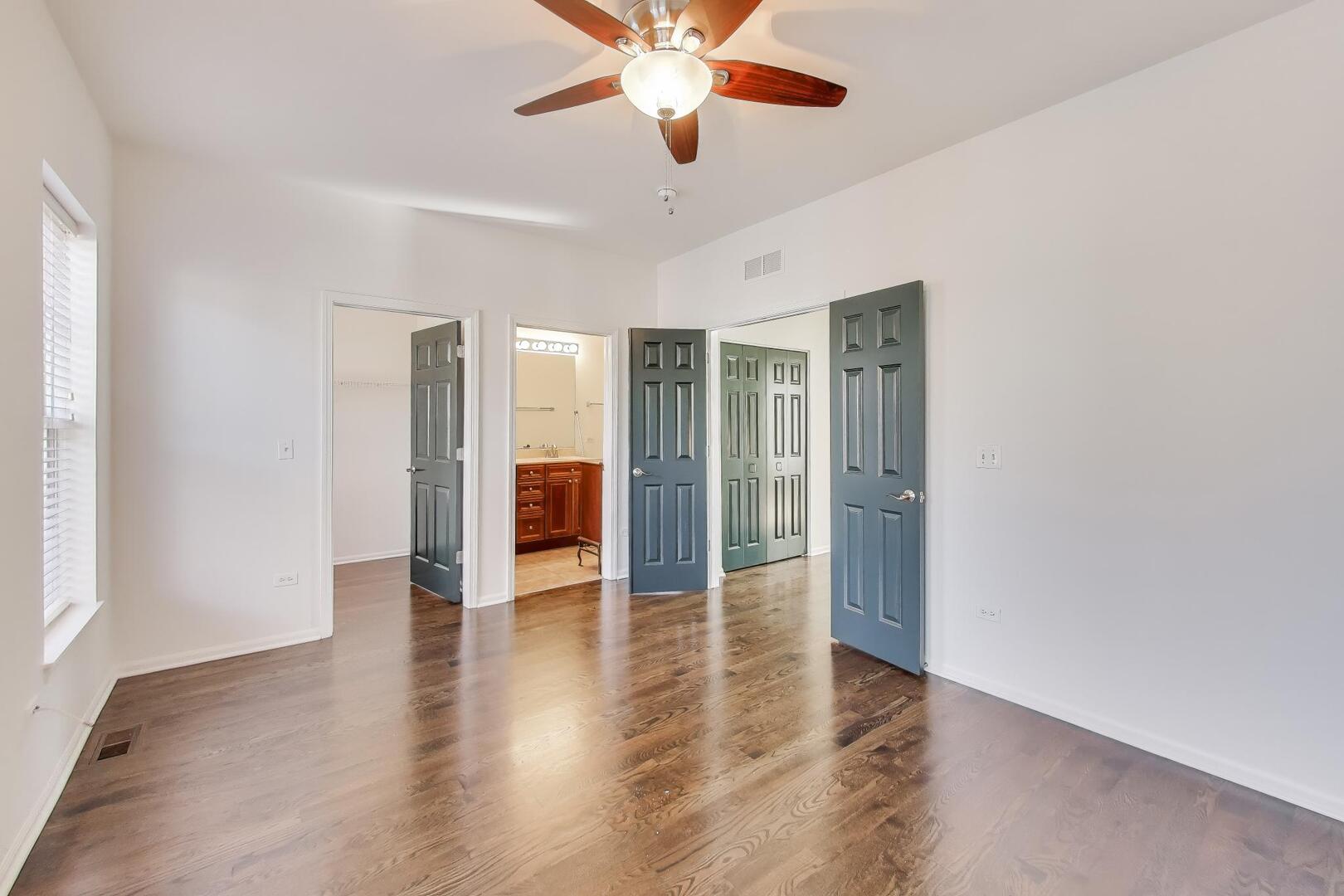 513 Grove Lane Forest Park, IL 60130 - Photo 21 of 34 a view of an empty room with window a ceiling fan and wooden floor