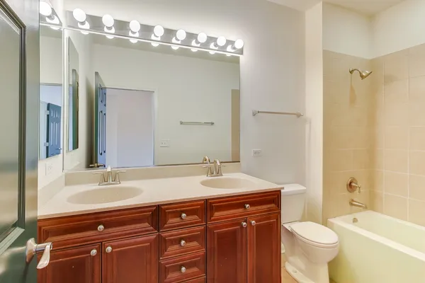 a bathroom with a sink vanity mirror and toilet