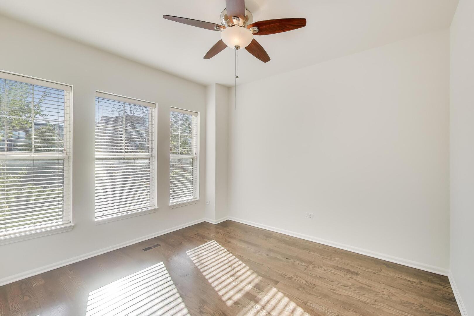 513 Grove Lane Forest Park, IL 60130 - Photo 25 of 34 a view of a bedroom with a window and a ceiling fan