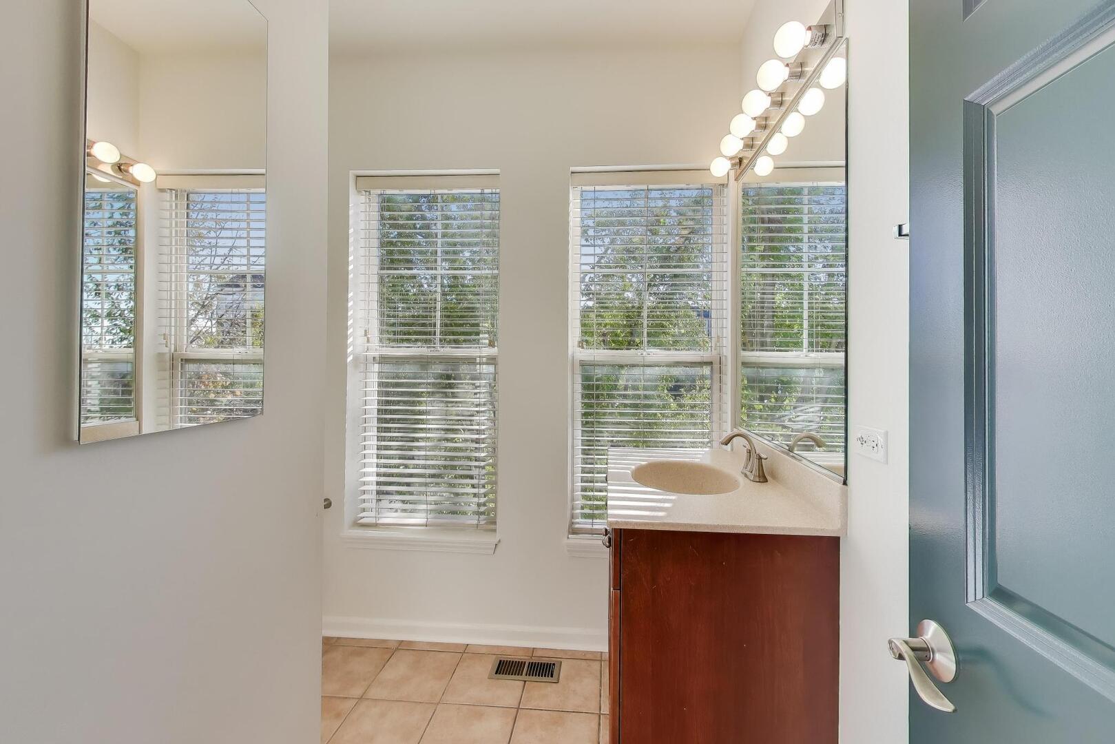 513 Grove Lane Forest Park, IL 60130 - Photo 27 of 34 a bathroom with a sink and a window