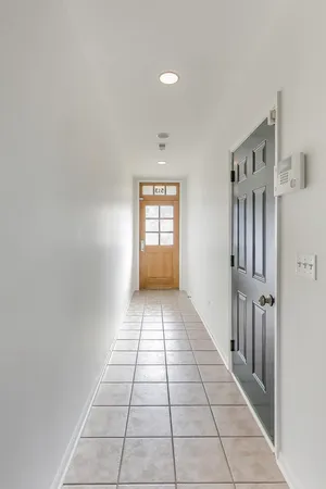 a view of a hallway with a window and a kitchen