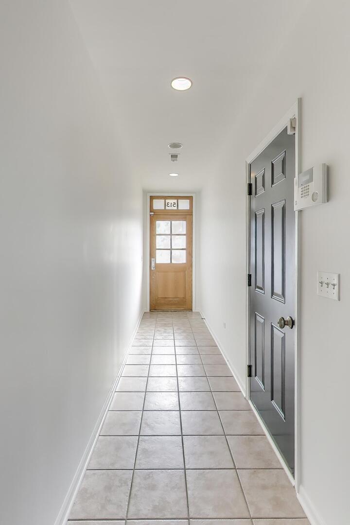 513 Grove Lane Forest Park, IL 60130 - Photo 5 of 34 a view of a hallway with a window and a kitchen